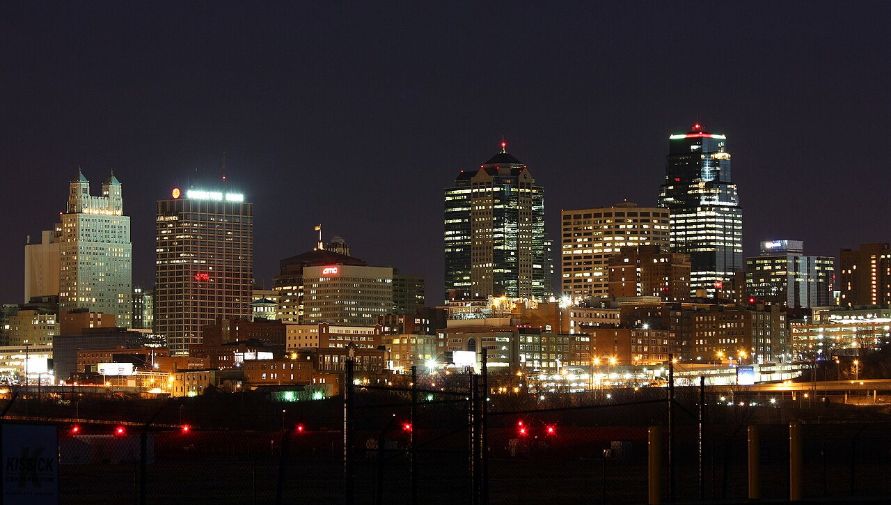 Kansas City’s downtown towers glowing against a dark night sky.